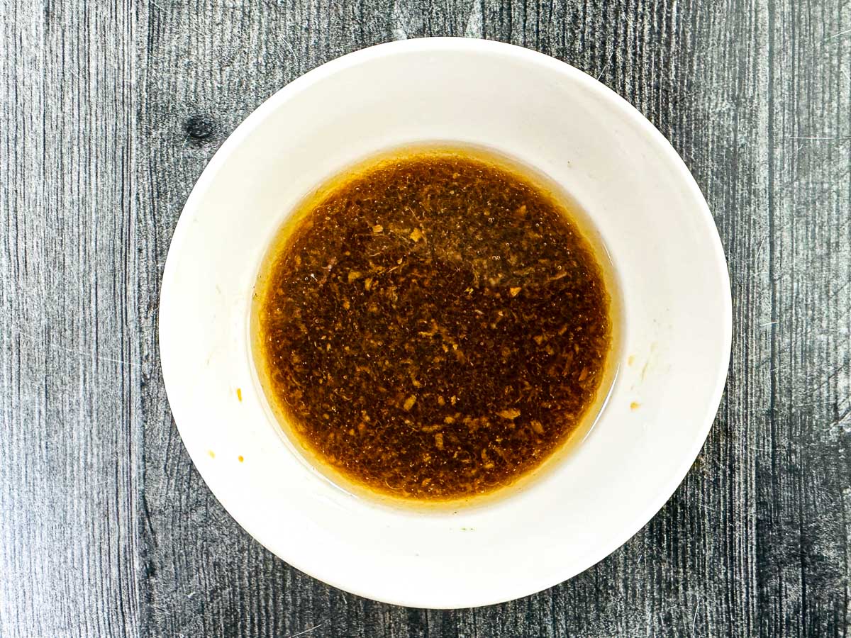 A white bowl with the dipping sauce.