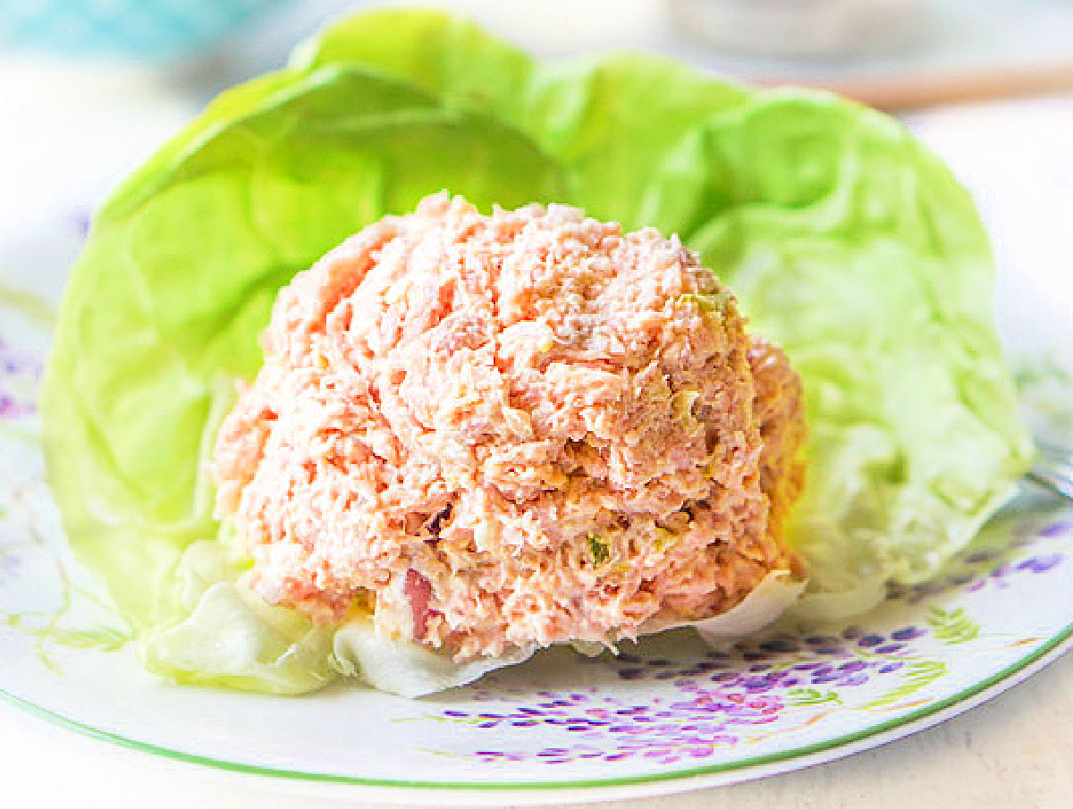 A scoop of keto ham salad using leftovers on a bed of lettuce.
