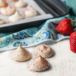cookie tray in background with low carb meringue cookies and strawberries