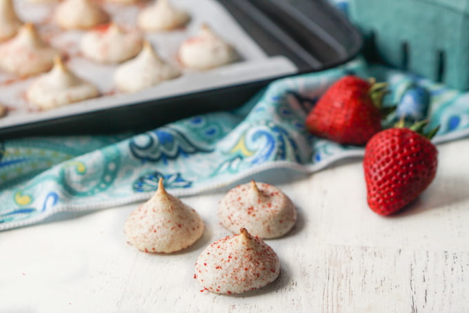 cookie tray in background with low carb meringue cookies and strawberries