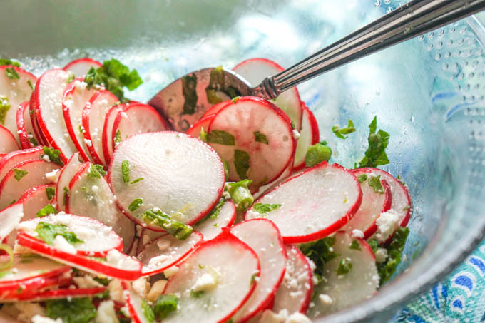 closeup of glass bowl of radish salad
