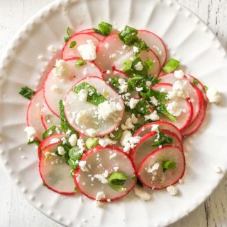 small white plate with radish salad and feta cheese