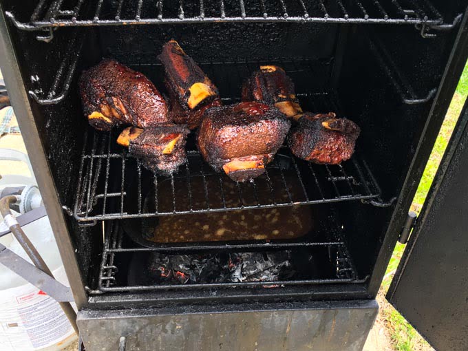 smoker opened showing bbq short ribs