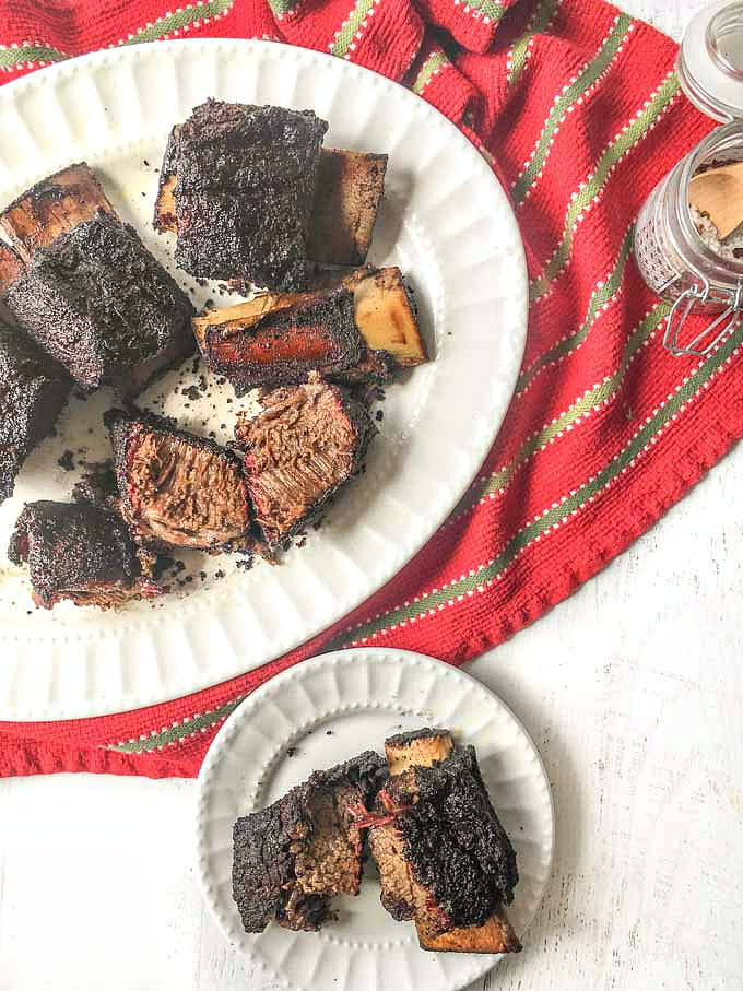 white platter with smoked bbq short ribs on red towel