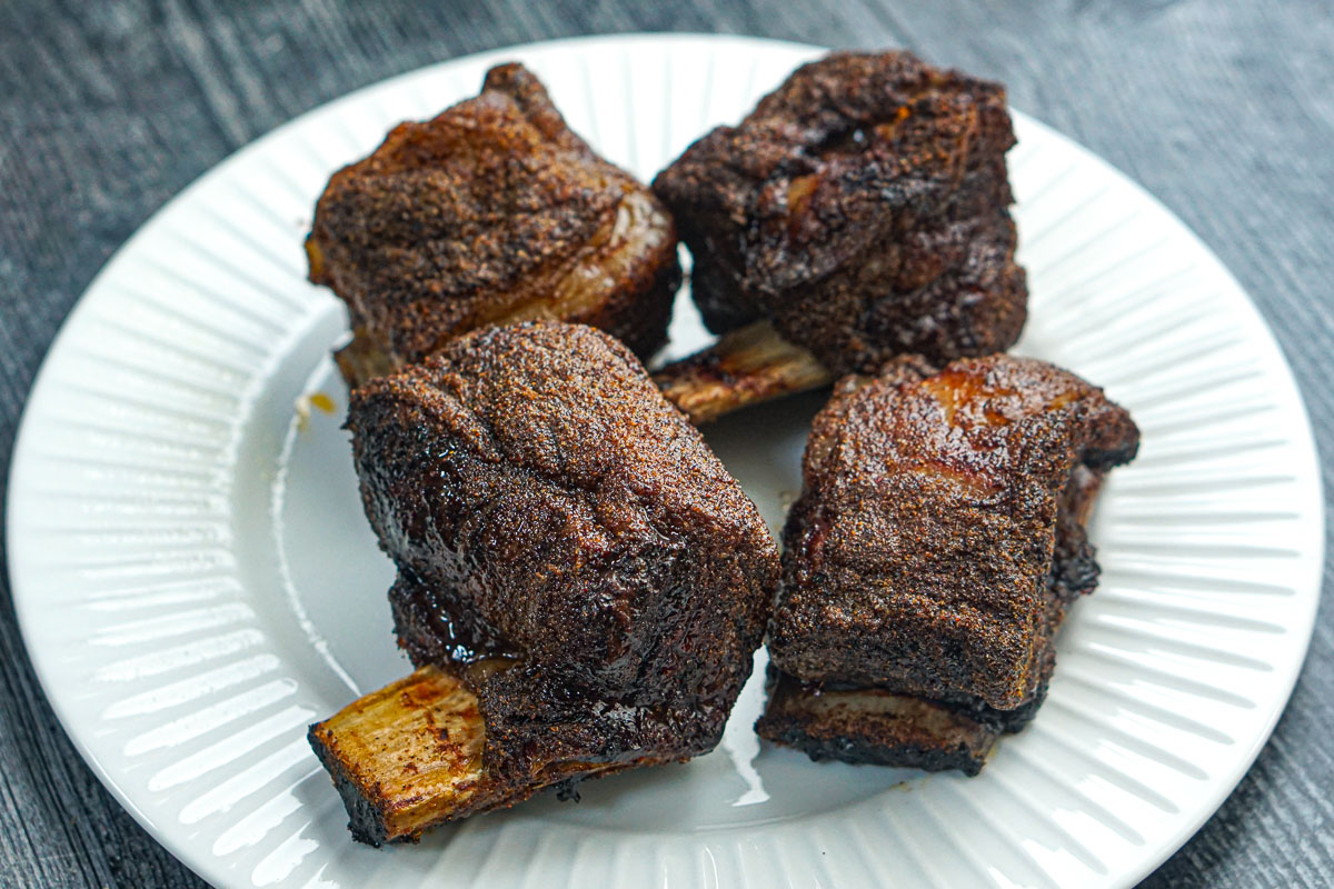 Closeup of a white plate with finished ribs.