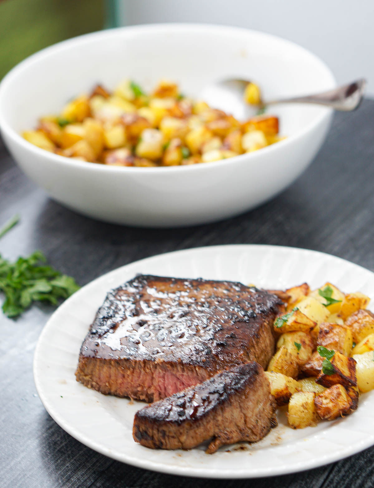 white plate with steak and potatoes