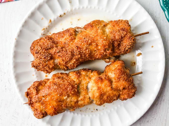 white plate with 2 gluten free city chicken pieces made in the air fryer.