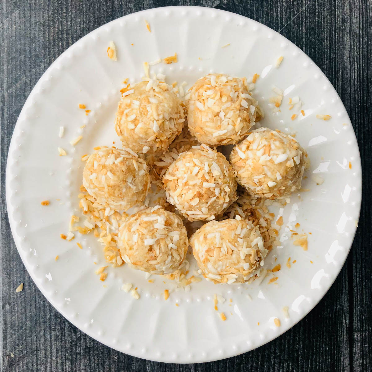 white plate with 7 keto coconut protein balls