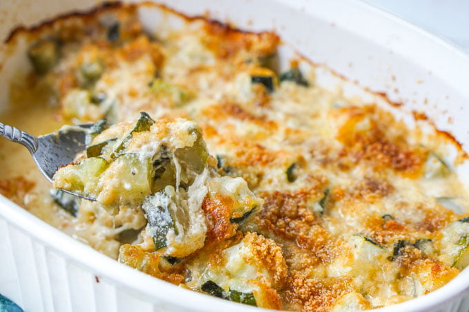 closeup up of low carb zucchini au gratin with a spoonful 