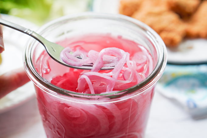 fork in a jar of pickled red onions