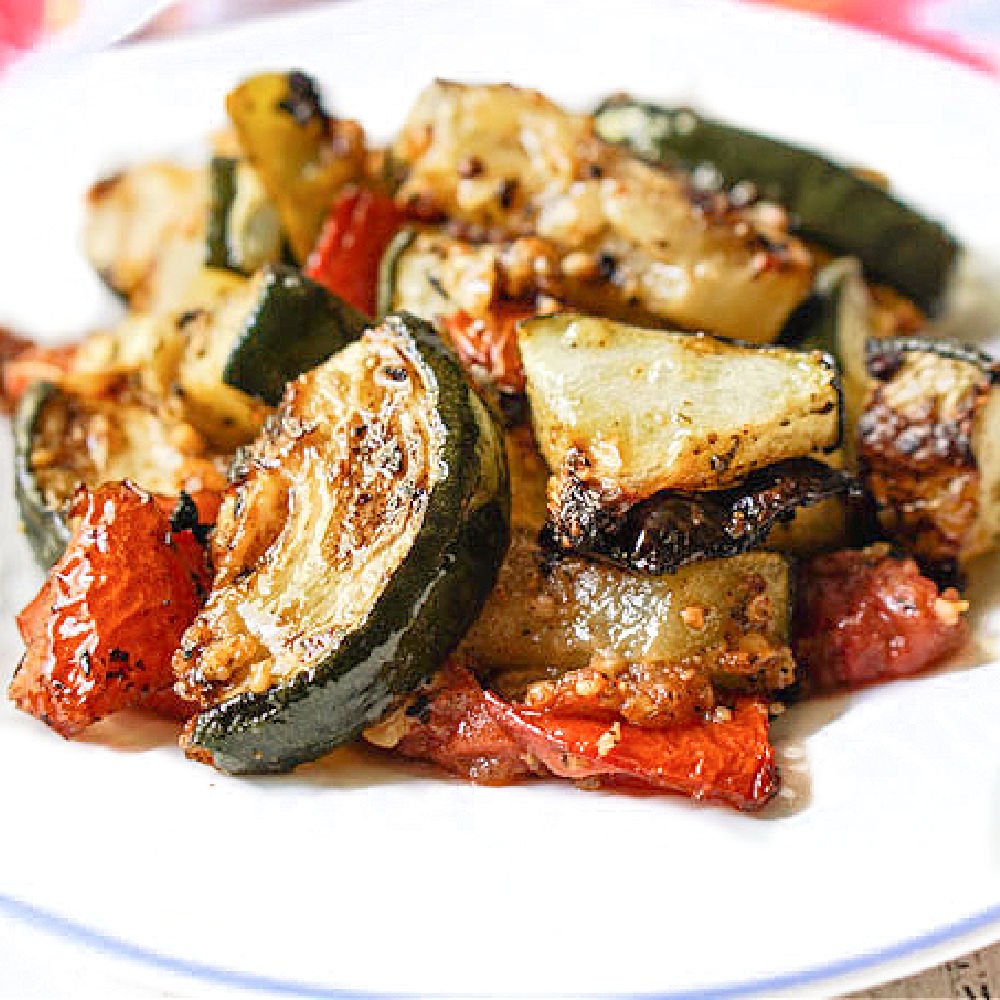 closeup up of white plate with keto roasted Zucchini and tomatoes