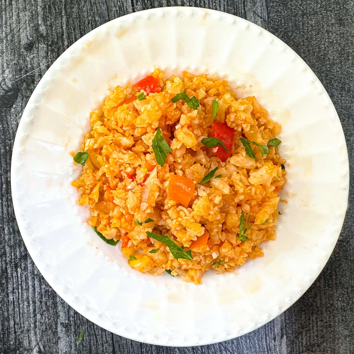 white plate with keto Spanish cauliflower rice