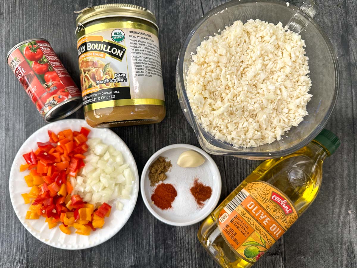recipe ingredients - riced cauliflower, better than bouillon, spices, tomato paste, chopped veggie and olive oil