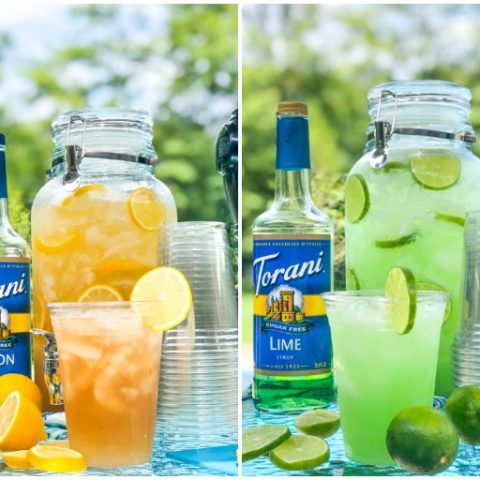 Spiked Iced tea and Margarita punch in large containers with Torani bottles, cups and sliced fruit outside