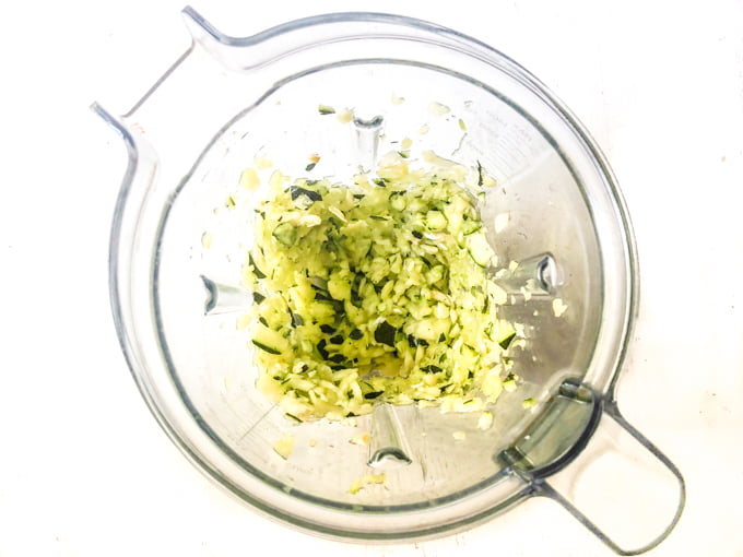 blender container with raw, shredded zucchini