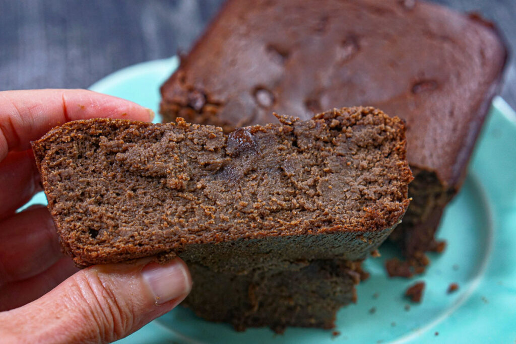 Hand holding a slice of the finished recipe.