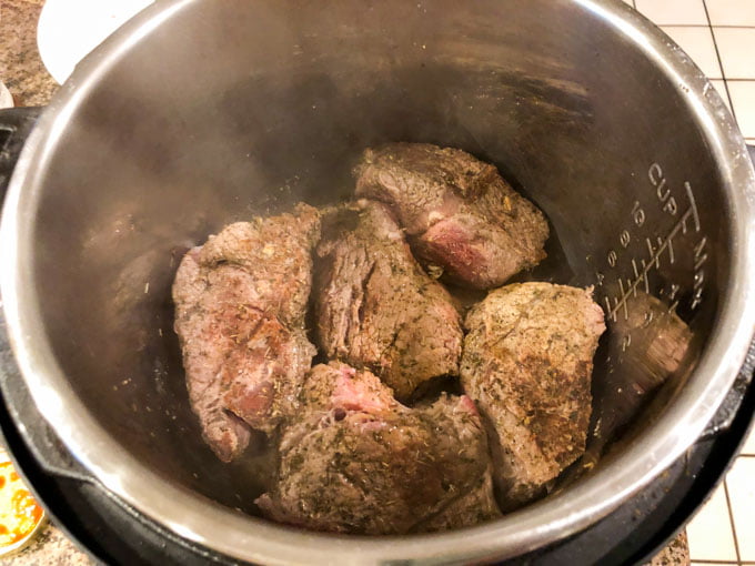 instant pot with brown pieces of big chunks of beef