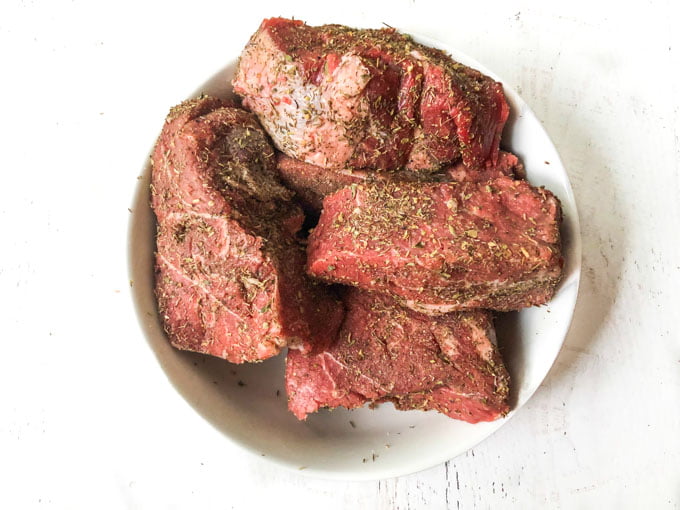 white bowl with spice rubbed big chunks of beef