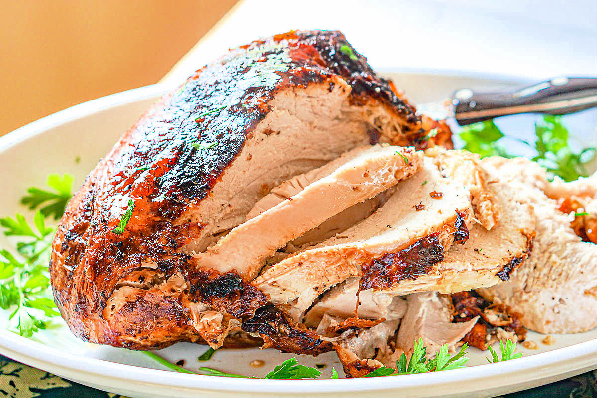 Closeup of a platter with the finished air fryer turkey sliced.
