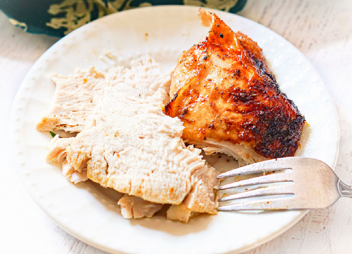 Closeup of a white plate with a serving of the meat.