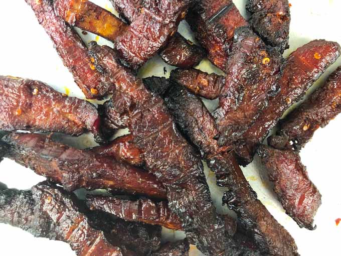 closeup up of strips of low carb smoked beef jerky