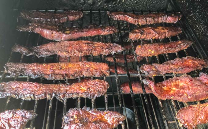 the inside of the smoker with pieces of low carb beef jerky on rack