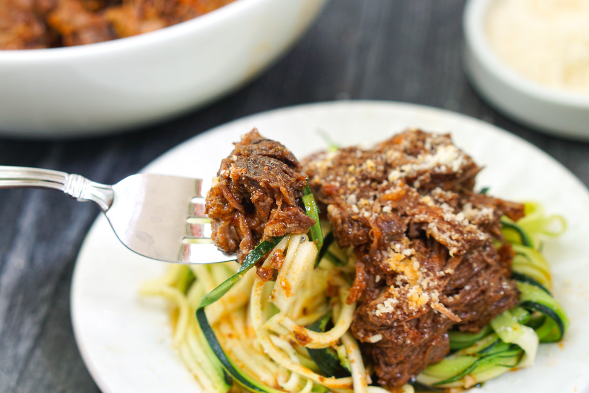 a forkful of zucchini noodles topped with Italian shredded beef