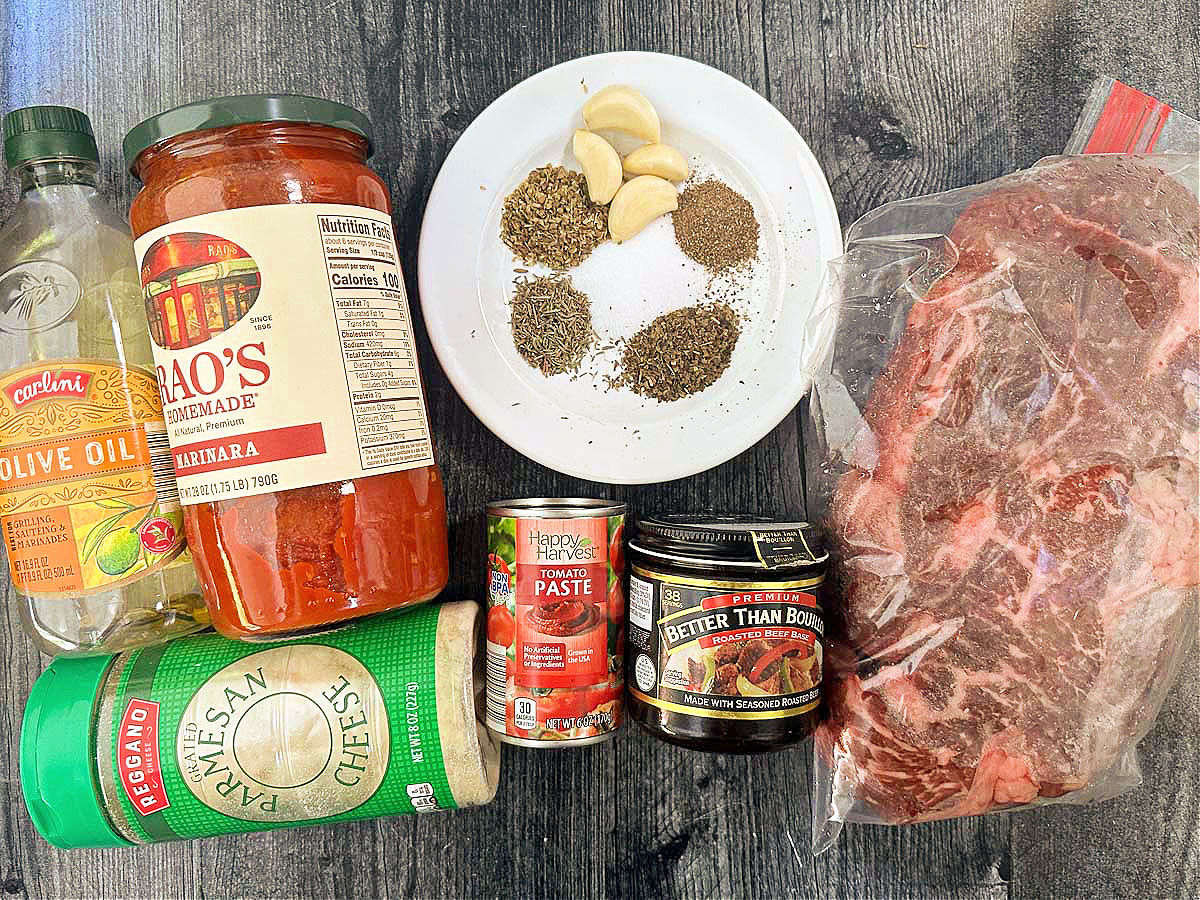 recipe ingredients - chuck roast, spices, Rao marinara, Better than Bouillon, tomato paste, olive oil and parmesan cheese