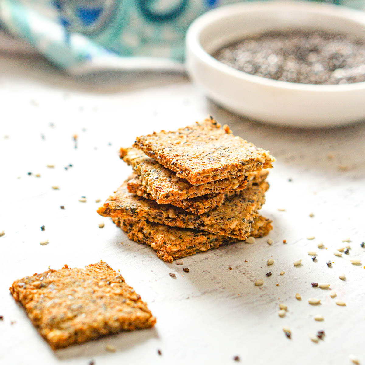 stack of keto crackers with scattered seeds