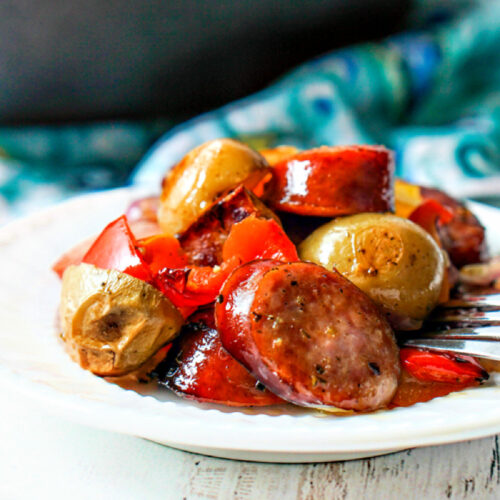 closeup of a plate of baked kielbasa and potatoes recipe