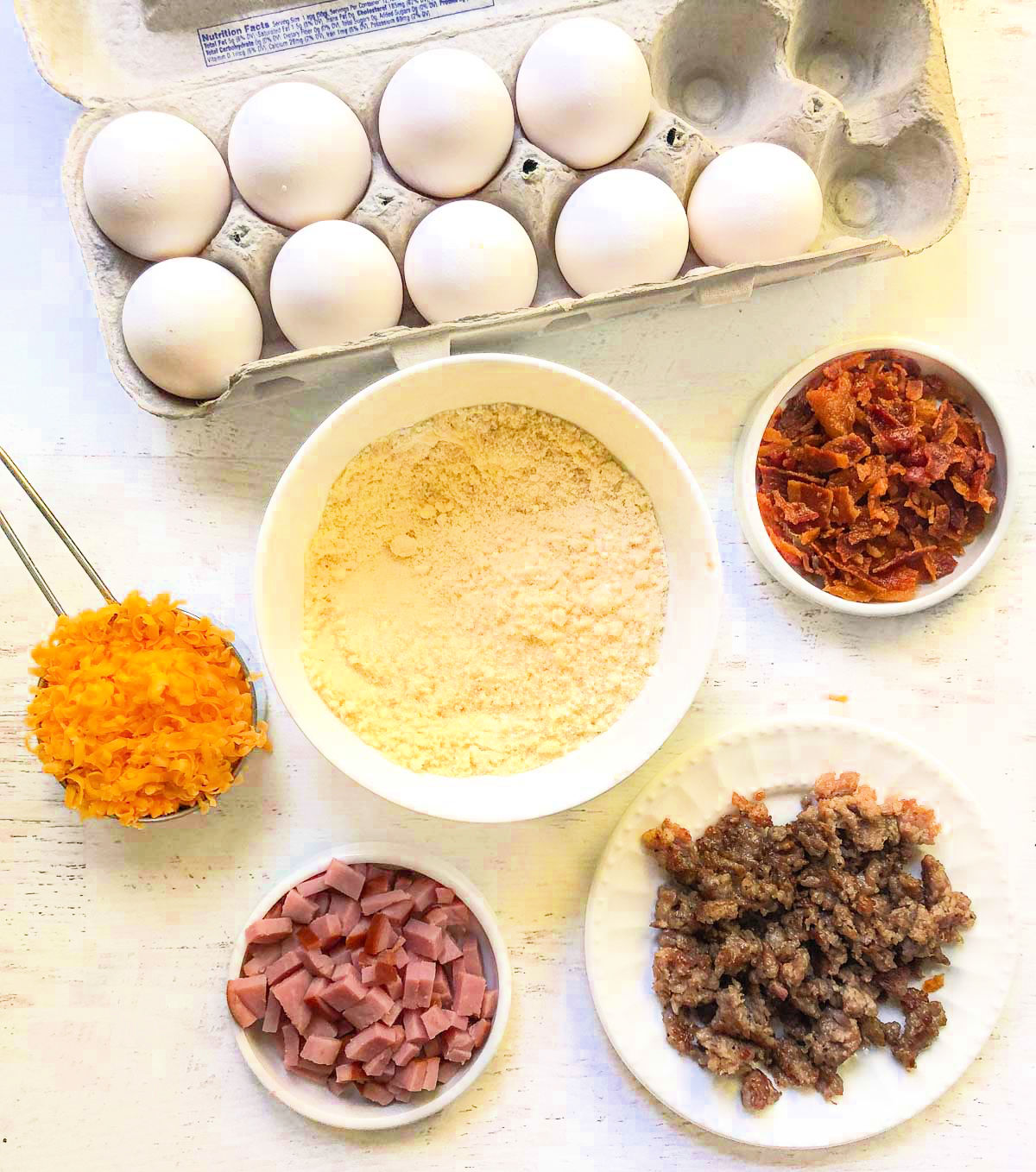 recipe ingredients - eggs, cheese, almond flour, bacon, ham and sausage