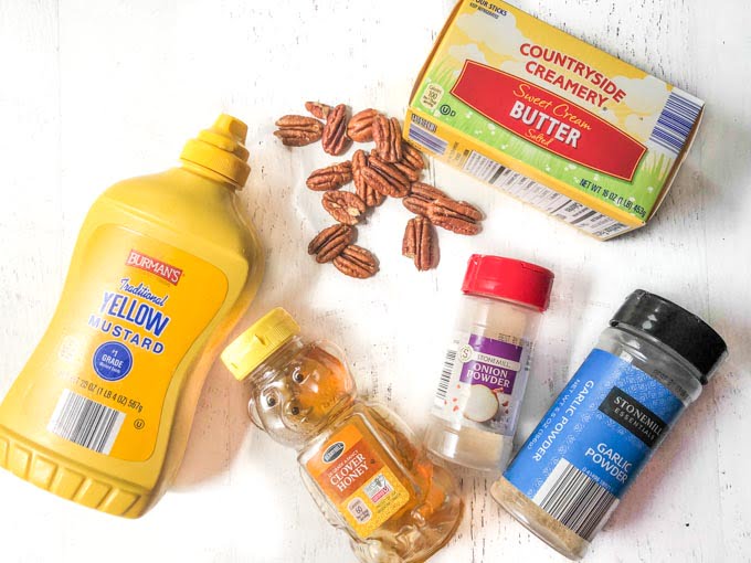 ingredients to make honey mustard pecans: mustard, honey, pecans. butter, onion powdering garlic powder