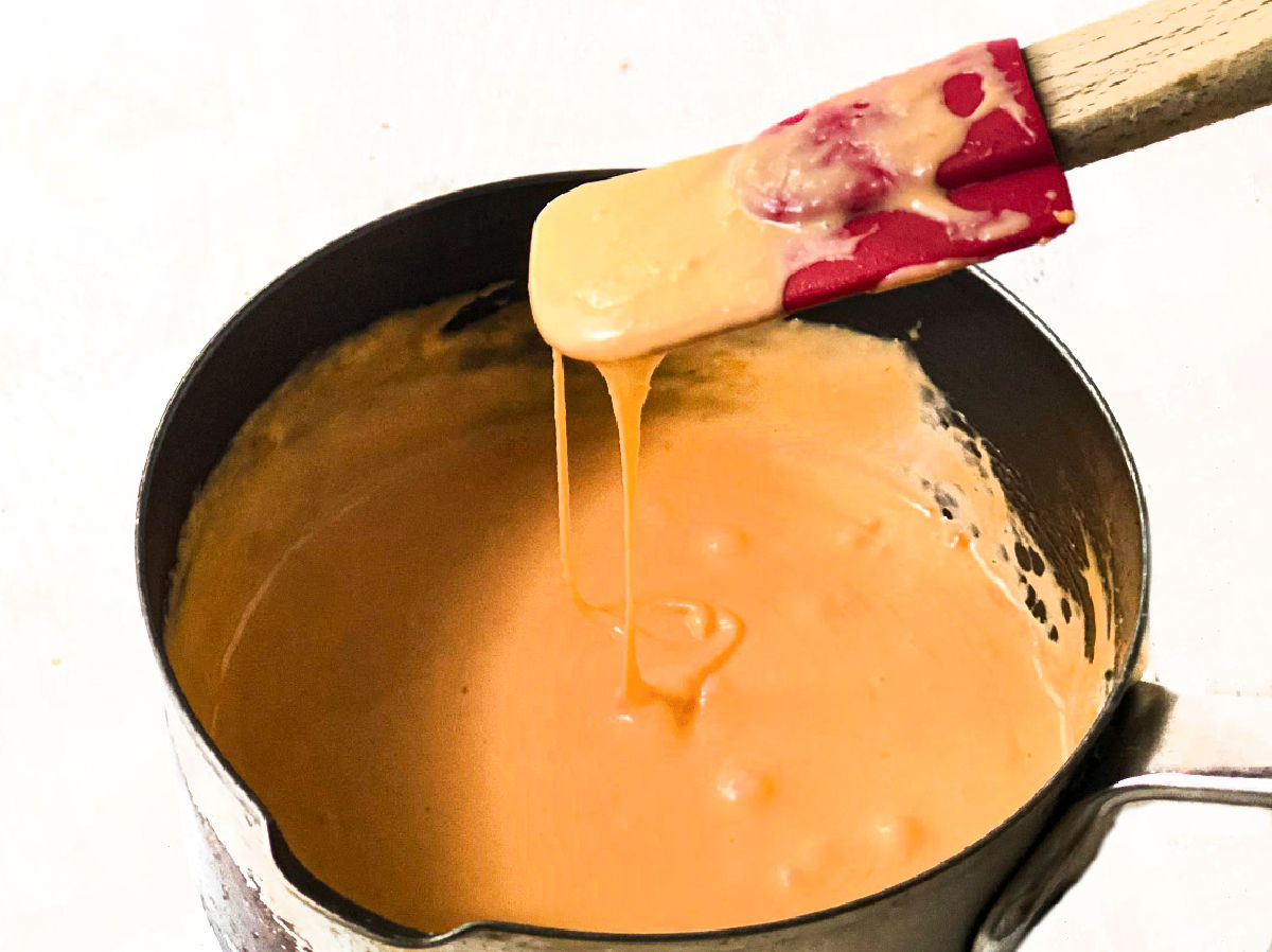 closeup of pan of melted cheesy sauce