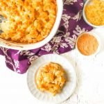 baked low cbaked low carb cauliflower and cheese on white place and baking dish with text overlayarb cauliflower and cheese in baking dish with with text overlay
