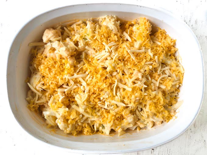 baking dish with unbaked cauliflower and cheese 