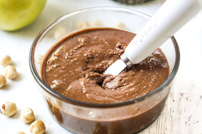 glass bowl with keto chocolate hazelnut butter with spreader knife
