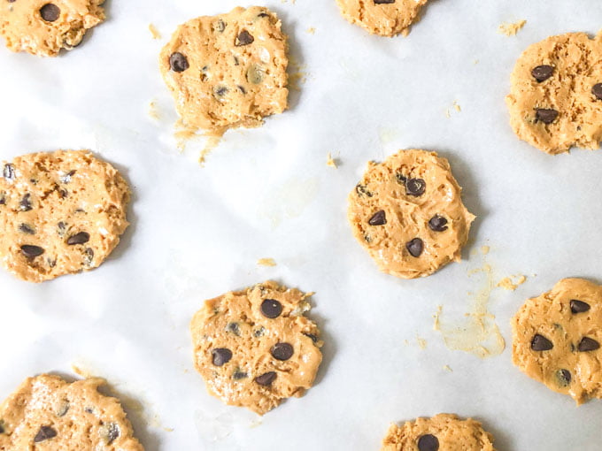 raw peanut butter cookie dough cookies on a parchment paper tray