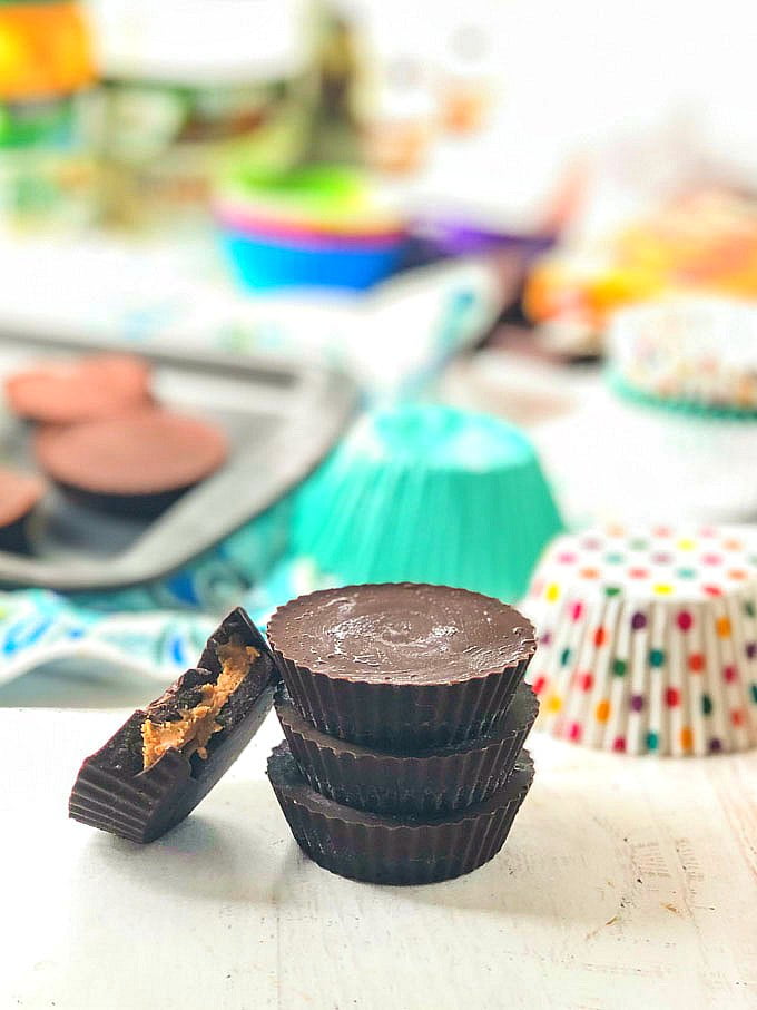 stack of low carb peanut butter cups stacked with ingredients in background