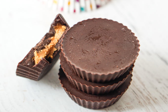 closeup of low carb peanut butter cups, one with a bit take out