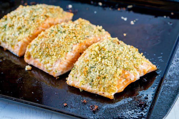 baked crusted salmon on a cookie sheet