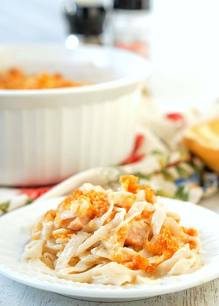 white plate with turkey casserole with baking dish in background