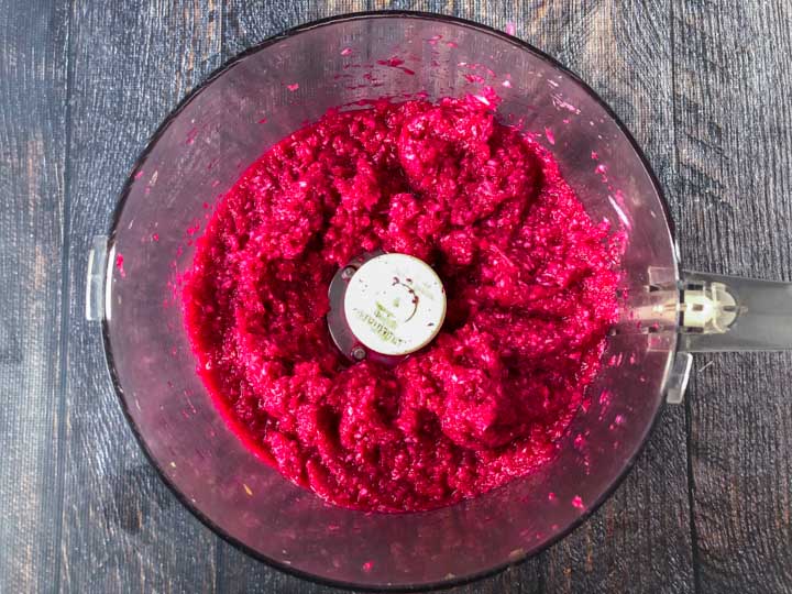bowl of food processor with beet & horseradish sauce in it