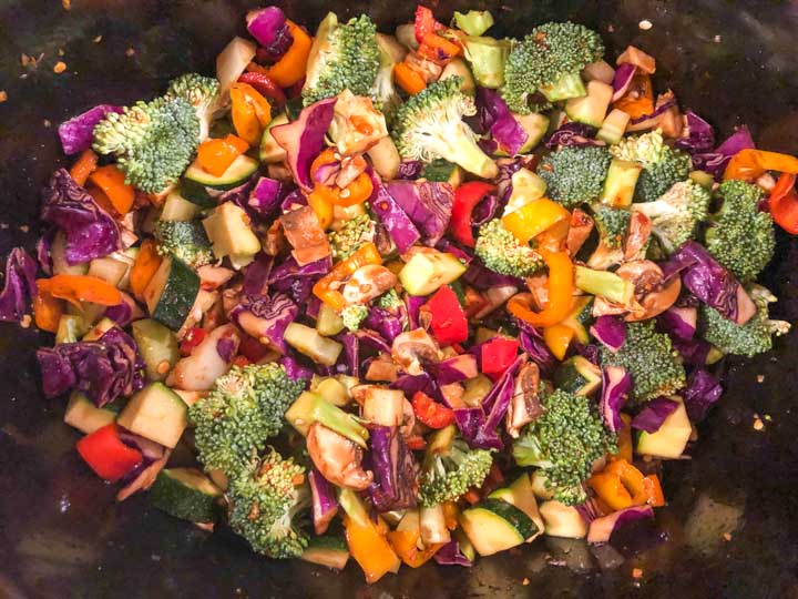 colorful raw stir fry vegetables in the slow cooker before cooking