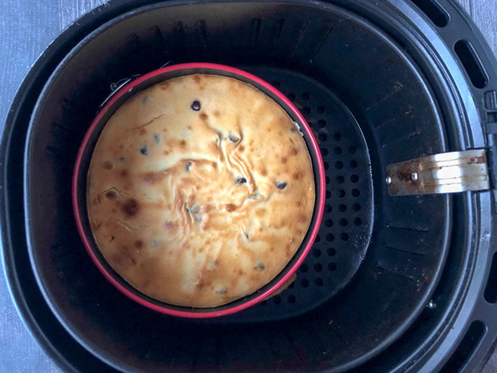 cooked keto chocolate chip cheesecake in pan in an air fryer basket