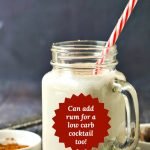 glass jar with low carb eggnog shake with striped straw and text