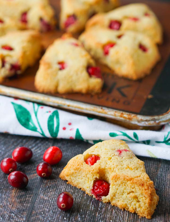 cookie sheet with keto cranberry orange scones and closeup of one of them