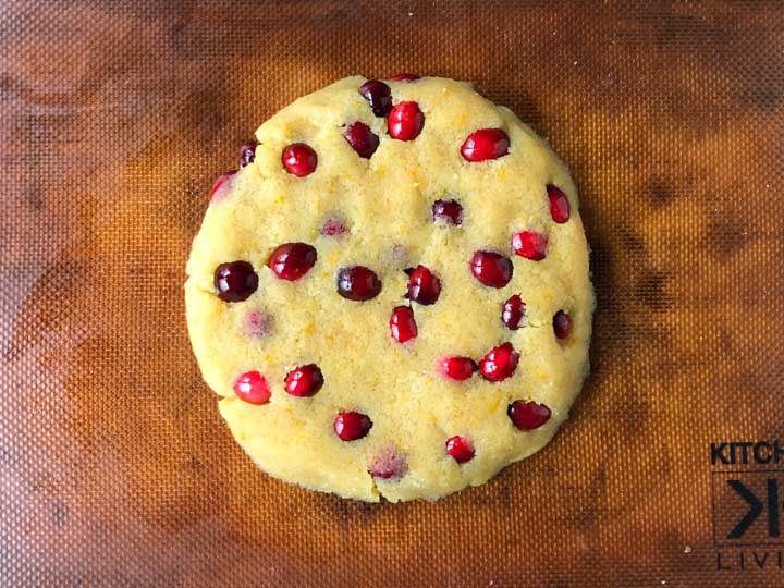 keto cranberry scone dough in a round shape on silpat cookie sheet