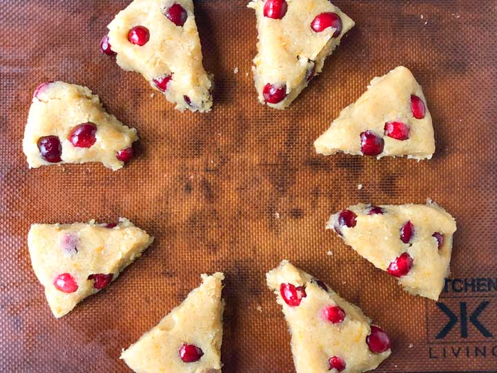 cranberry scone dough cut up into 8 pie pieces on cookie sheet
