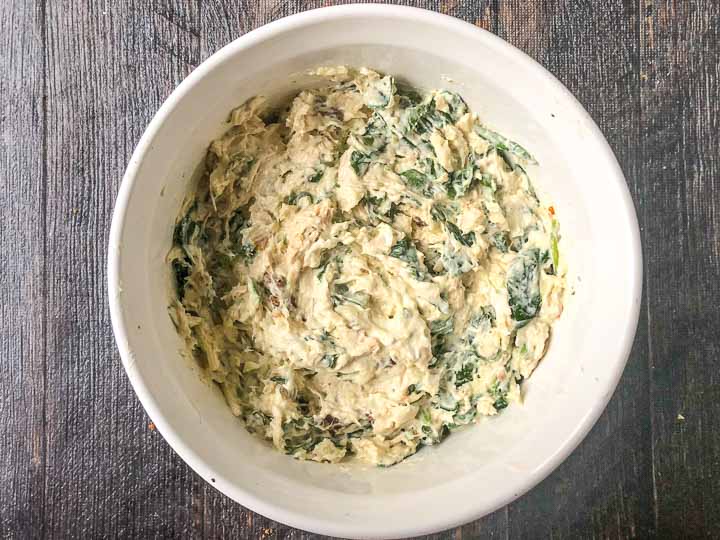 white baking dish with uncooked low carb Italian chicken dip