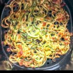 air fryer basket filled with keto cheesy zucchini noodles with text